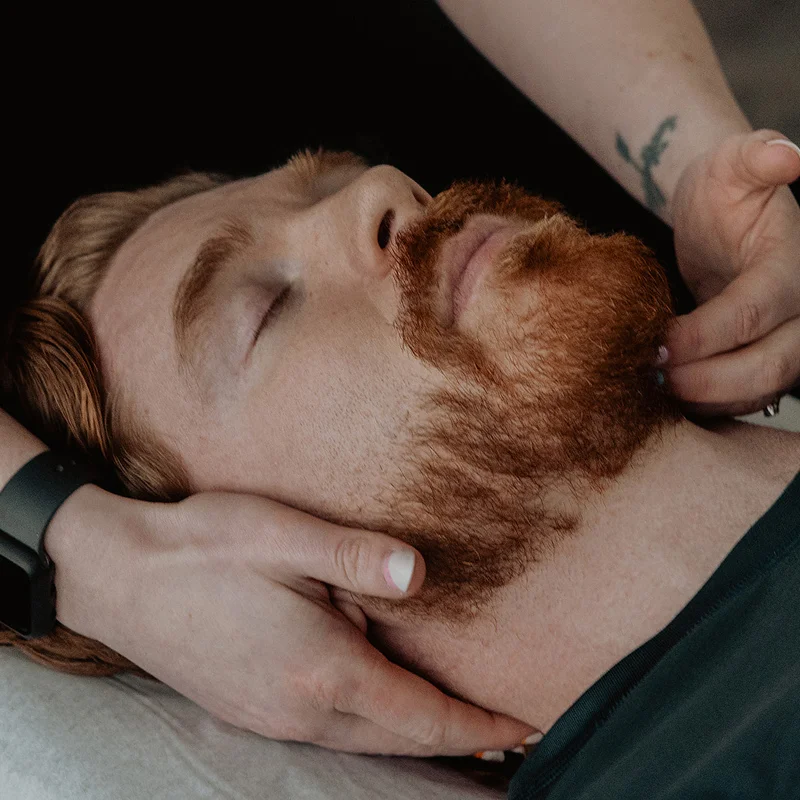 Close-up of chiropractor treating temporomandibular joint for jaw pain and TMJ disorder in Kelowna