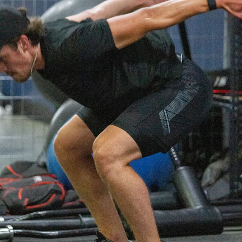 Athlete performing dynamic movement screen during kinesiology assessment in Kelowna