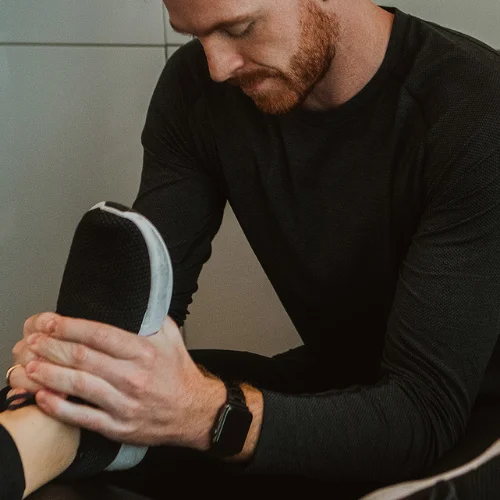 Physiotherapist performing ankle mobility treatment to improve flexibility and reduce pain