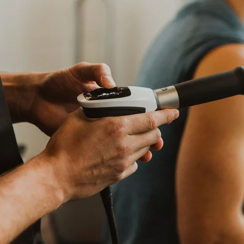 Shockwave therapy device used for pain relief and soft tissue treatment at Pro Motion Clinic Kelowna