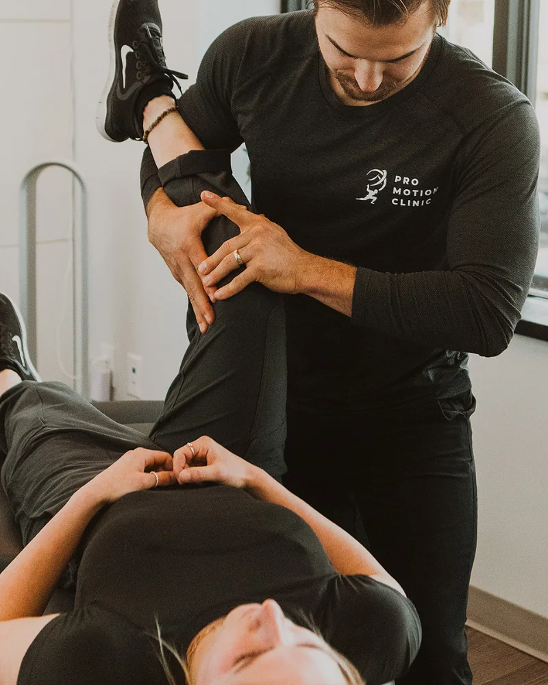 Therapist performing myofascial release on lower body to reduce muscle tightness and improve movement