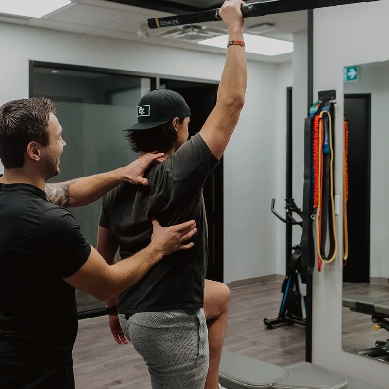 Kinesiologist guiding full-body movement screen to assess mobility and functional performance