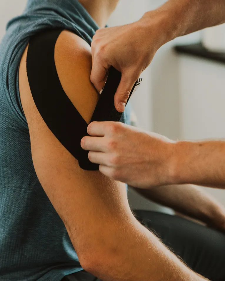 Kinesiology taping applied on shoulder to support muscles during physiotherapy recovery
