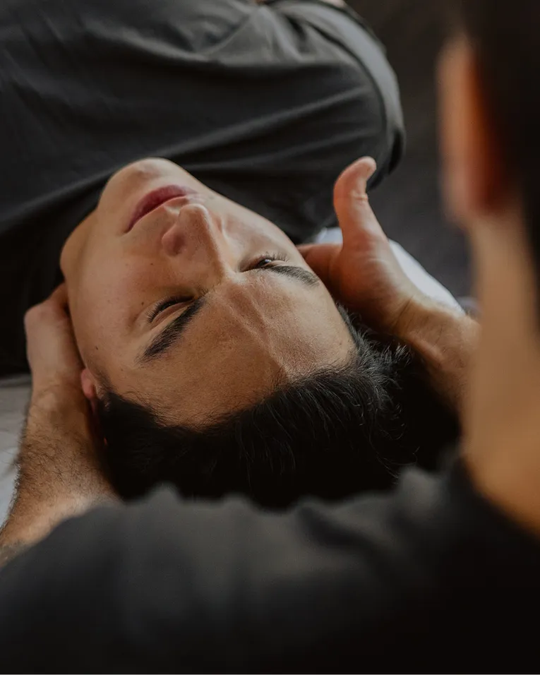Chiropractor performing neck adjustment to relieve pain and improve mobility in Kelowna