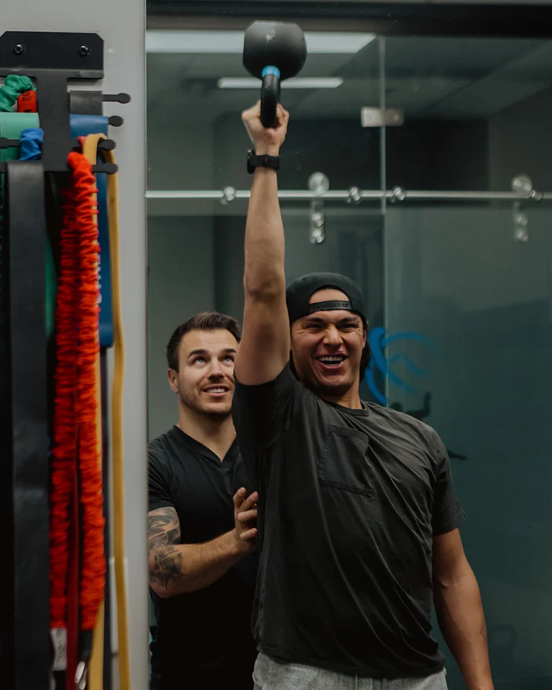 Movement screen assessing overhead strength and shoulder stability at Pro Motion Clinic Kelowna