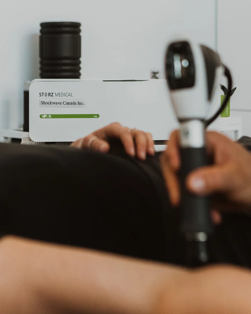 Storz Medical shockwave therapy unit and handpiece in use during soft tissue treatment at Pro Motion Clinic Kelowna