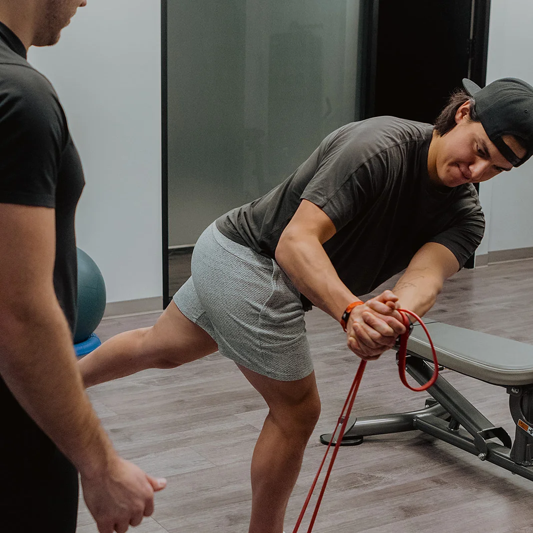 Patient performing resistance band exercise during physiotherapy rehab in Kelowna clinic