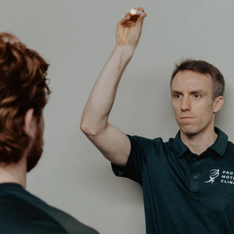 Pro Motion Clinic chiropractor performing visual tracking test during vestibular assessment in Kelowna