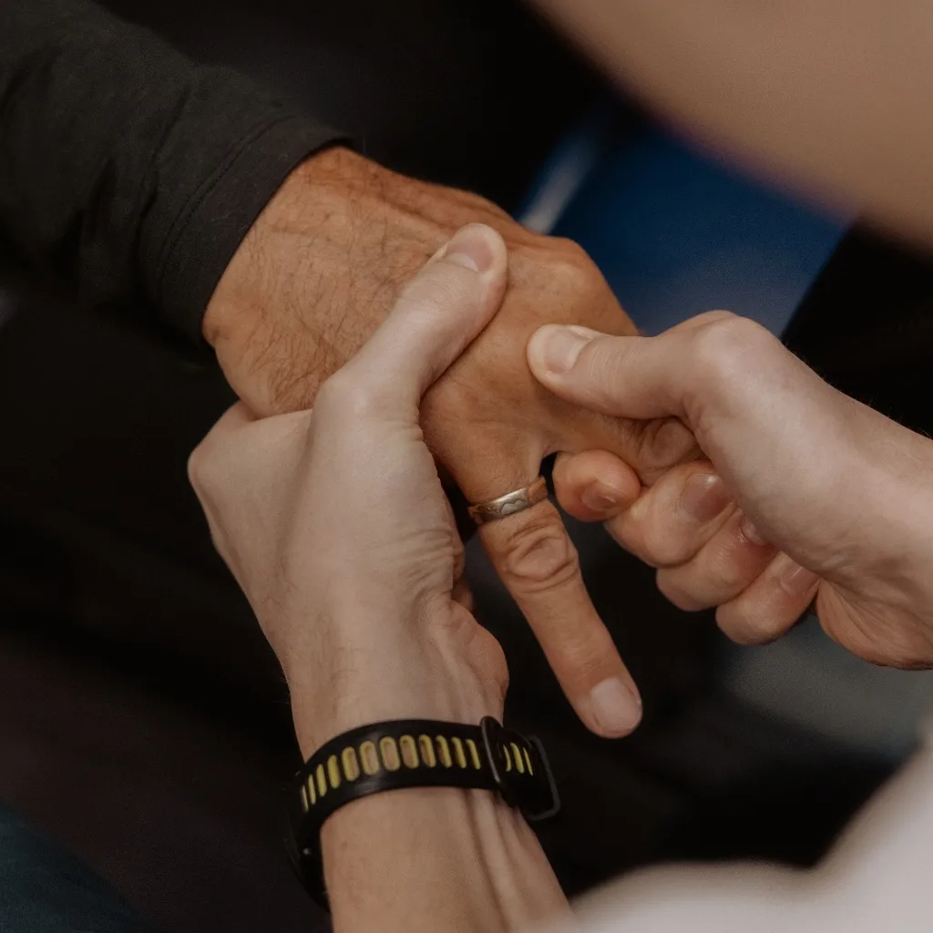 Physiotherapist performing finger and hand joint mobilization for osteoarthritis management in Kelowna