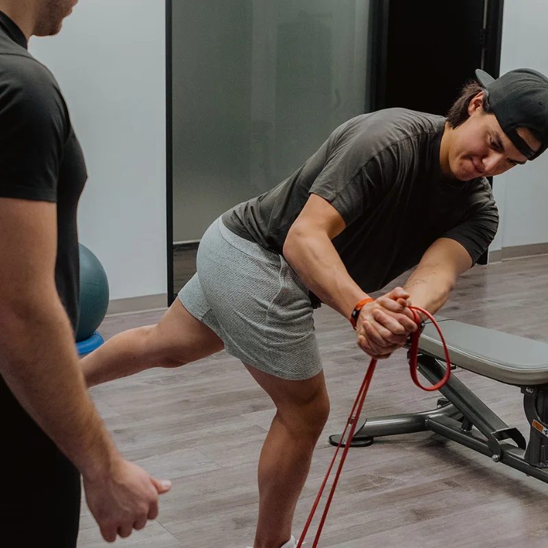 Athlete performing single-leg resistance band exercise to improve strength and balance in Kelowna